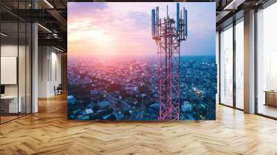 A telecommunication mast with 5G antennas, towering over a modern city, symbolizing advanced wireless technology. Wall mural