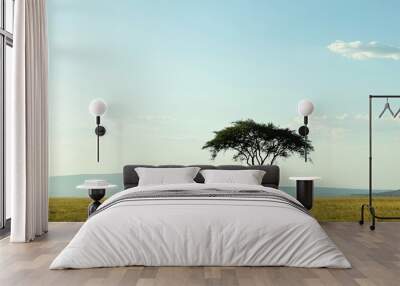 The endless horizon of the Serengeti, with a single acacia tree silhouetted against the sky. Wall mural