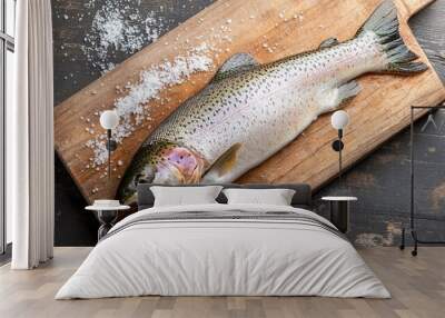 Whole rainbow trout with a sprinkle of kosher salt on a wooden board, perfect for a culinary scene. Wall mural