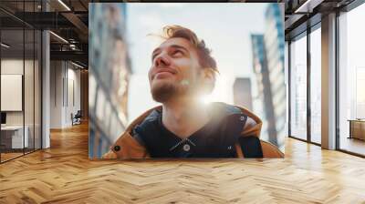 Happy young caucasian man looking up at the sky alone in a busy city.
 Wall mural