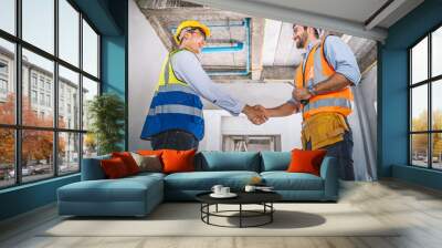 Two engineer shaking hands with deals and congratulations on success. Wall mural