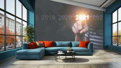 Woman ues finger pointing 2021 happy new years christmas eve. Wall mural