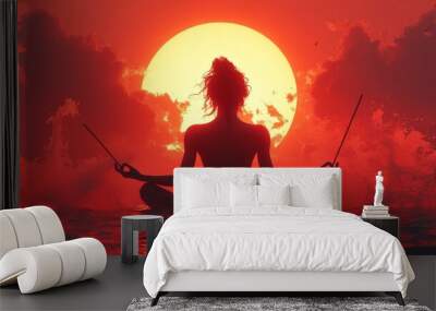 Silhouette of a person meditates on water at sunset, holding sticks, surrounded by vibrant red and orange hues Wall mural