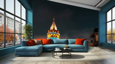 View of Galata Tower illuminated with lights at night in Istanbul, Turkey. Wall mural