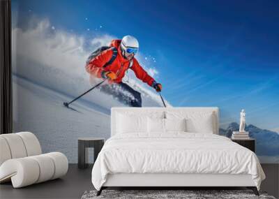 Skier carving down a powdery slope against a clear blue sky Wall mural