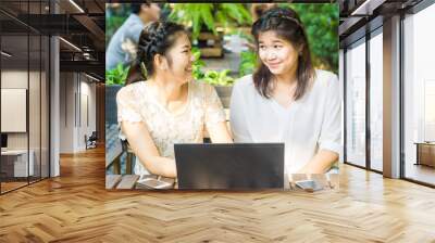 Asian businees women enjoying with her friend on laptop Wall mural