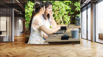 Asian businees women enjoying with her friend on laptop Wall mural