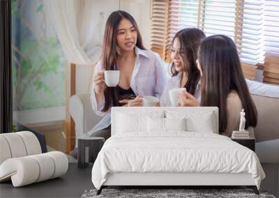 Asian Female Friends Enjoying Breakfast Hold Coffee Cup Wall mural