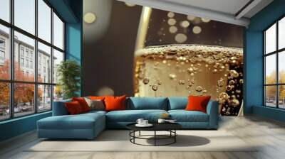 A glass of champagne with bubbles in it Wall mural