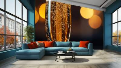 A glass of champagne with bubbles in it Wall mural