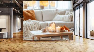 A living room with a white sofa, wooden coffee table, autumn-themed decor and candles on the table Wall mural