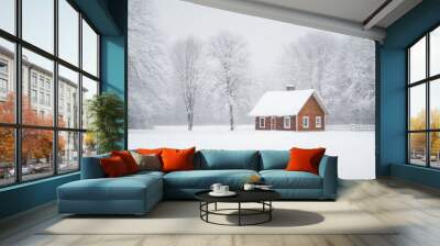 A small red house sits in a snow-covered field Wall mural