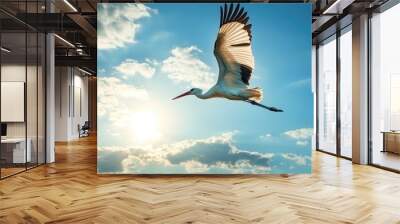 A stork flying gracefully, soft light shining on its wings Wall mural