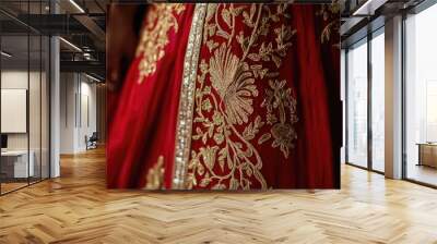 A woman is wearing a red dress with gold embroidery Wall mural