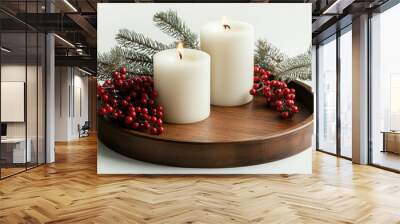 A wooden tray with two candles and berries on it Wall mural