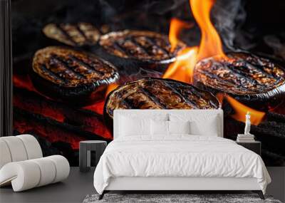 Eggplant slices with grill marks roasting over red-hot coals Wall mural