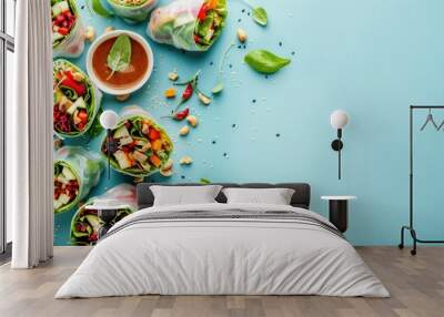 Fresh vegetable spring rolls with peanut sauce on a light blue background Wall mural