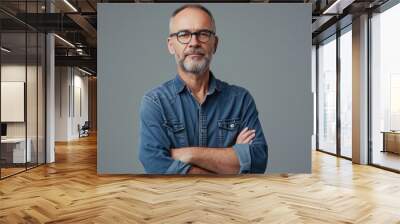 Middle aged man wearing casual standing against neutral gray background and looking at camera Wall mural