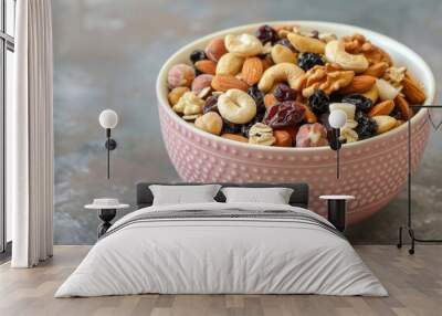 Mixed nut and dried fruit trail mix in a pastel pink bowl Wall mural