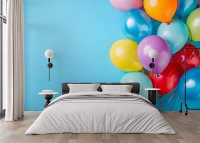 A bunch of colorful balloons on a light blue background. Wall mural