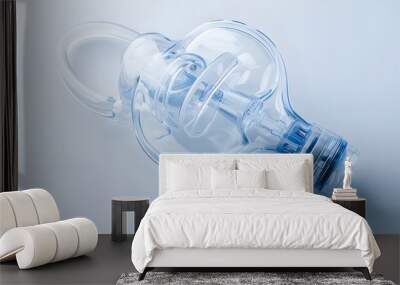 A clear stock photo of a nebulizer, featuring its mask and medication cup, set against a white backdrop. Wall mural