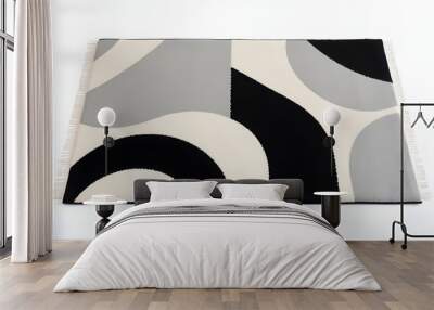 A modern rug with bold geometric shapes in black, white, and gray tones, placed flat on a white background.  Wall mural