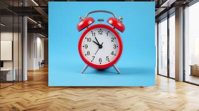 Red alarm clock on blue background
 Wall mural