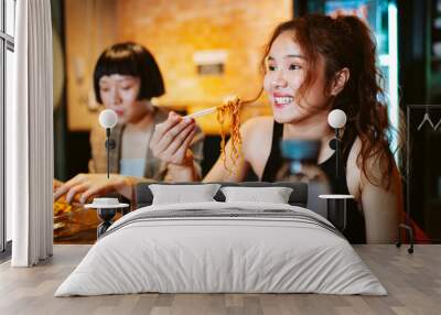 Asian business people take a break having lunch together in kitchen. Wall mural