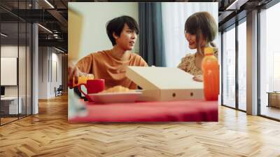 Asian thai couple preparing food in kitchen dinning room. Wall mural