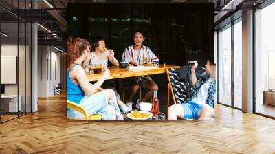 Group of young people having fun in summer trip at hotel lounge. Wall mural