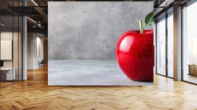 Single red apple with a leaf on a gray textured background Created with Generative AI. Wall mural