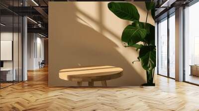 Wooden round side table with green tropical plant leaf and beautiful sun light and shadow on beige wall for luxury beauty, organic, health, cosmetic, jewelry fashion product display background
 Wall mural