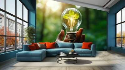 Hand hold light bulb with nature green leaf Wall mural