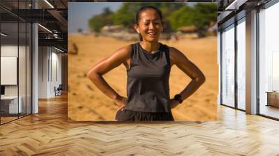 portrait of young attractive and sweaty happy Asian Indonesian woman in her 40s smiling satisfied after hard beach running workout in sports training and healthy lifestyle concept Wall mural