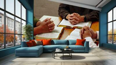 Christian Bible Study Concepts. Christian group or family prayer together with a holy bible on a wooden table in church for worship to god in the morning. people pray with faith, Spirituality. Wall mural