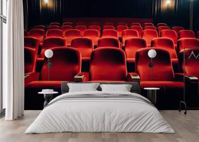 A dark theater is filled with rows of vibrant red seats for audience members to sit and enjoy a performance Wall mural