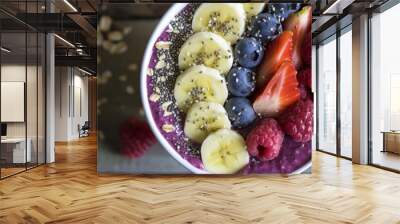 A delicious bowl of smoothie made with natural foods including bananas, blueberries, raspberries, and oats. A refreshing dessert packed with fruit and plantbased ingredients Wall mural