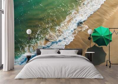 Aerial view of sandy coast with green beach umbrella Wall mural