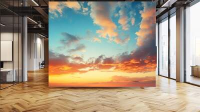 As the sun sets on a summer evening the sky transforms into a stunning blend of blue and orange creating a captivating background against the landscape The clouds take on a warm yellow hue  Wall mural