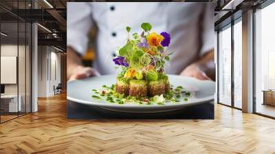 Chef with vegetarian dish adorned with an avocado flower, close-up at a fancy restaurant. Wall mural