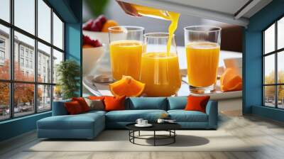 Fresh juices being poured at hotel breakfast table in the morning. Wall mural