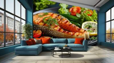 Grilled salmon fillet accompanied by a salad of green peppers, cherry tomatoes, and lettuce, finished with a lemon slice, displayed on a table. Wall mural