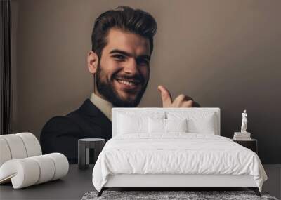 Handsome, successful businessman achieves company goal with a smile and a thumbs up. Wall mural