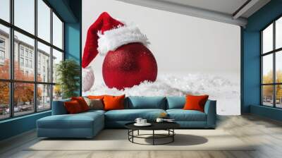 Red Christmas ball and Santa hat on white background Wall mural