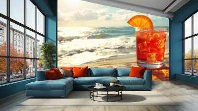 Refreshing Aperol Spritz drink with an orange garnish on a wooden table by the beach Wall mural