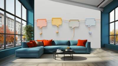 Speech bubbles suspended on a string with a light backdrop Wall mural