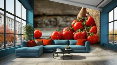 Tomatoes spilling from sack on wooden background Wall mural