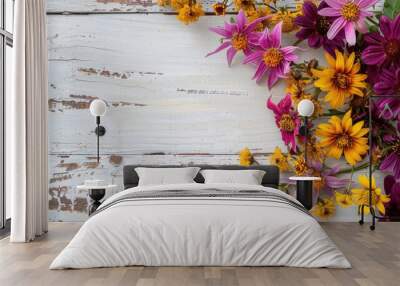 Vivid purple and yellow autumn flowers on white wood backdrop with text space Wall mural