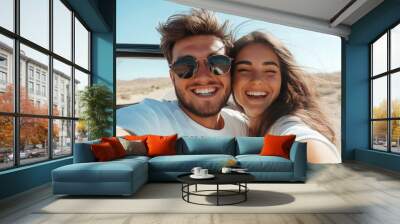 happy young couple laughing together on a road trip Wall mural