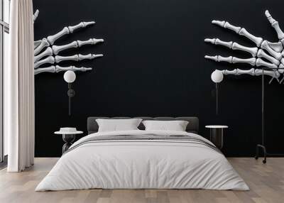 Two skeletal hands extend towards the edges of a dark background, creating a striking visual contrast and a sense of depth. Wall mural